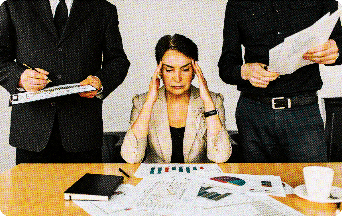 Image of woman sitting at a desk looking frustrated 